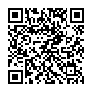 一个穿着中学生校服的店员男生捧着一个盘子从里面走出来二维码生成