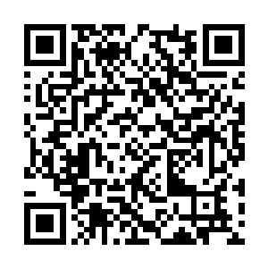 乾闼婆轮上刻着的是一个四只手臂的菩萨造型人物二维码生成