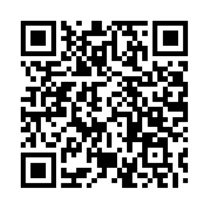 办公室主任戴志坐在办公室东南角落里二维码生成