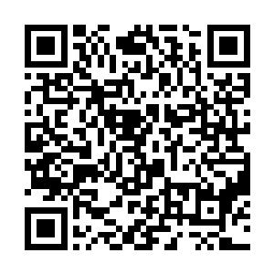 待看到幽谷之内四面山壁下一排排整齐的木屋和石洞二维码生成