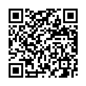 的台式钟表上搭着手工剪纸大喜字二维码生成